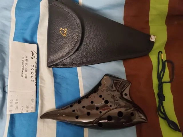 Ceramic ocarina with its leather carry case and the original receipt